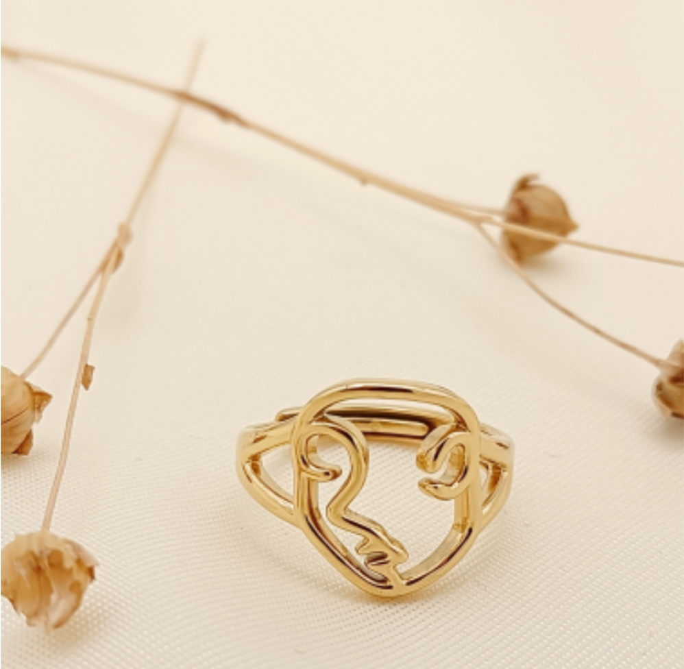 Bague dorée visage abstrait